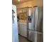 A laundry room with a stainless steel refrigerator, washer, and dryer at 4104 W North B St, Tampa, FL 33609