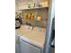 Laundry area with stacked washer and dryer and storage shelving at 4104 W North B St, Tampa, FL 33609