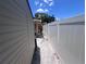 Narrow space in side yard, showing fence, storage shed and access to back yard at 4104 W North B St, Tampa, FL 33609