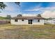 The backyard features a white fence, a well-maintained lawn, and mature trees at 416 Flamingo Dr, Apollo Beach, FL 33572