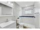 Updated bathroom features a white vanity and a walk-in shower with decorative tile at 416 Flamingo Dr, Apollo Beach, FL 33572