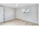 Bright bedroom with wood floors, a window, and neutral paint at 416 Flamingo Dr, Apollo Beach, FL 33572