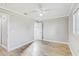 Cozy bedroom with ceiling fan, wood floors, and neutral paint at 416 Flamingo Dr, Apollo Beach, FL 33572
