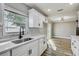Updated kitchen featuring white countertops, stainless steel sink, and a view to the dining area at 416 Flamingo Dr, Apollo Beach, FL 33572