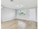 Bright living room featuring wood floors, a ceiling fan, and a white entry door at 416 Flamingo Dr, Apollo Beach, FL 33572