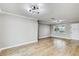 Inviting living space with wood floors and natural light from a large window at 416 Flamingo Dr, Apollo Beach, FL 33572