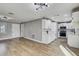 Open-concept living and kitchen area with wood floors and white cabinets at 416 Flamingo Dr, Apollo Beach, FL 33572