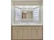 Bathroom vanity featuring a wide countertop and cabinets, flanked by glass block windows at 4512 24Th Ave S, Tampa, FL 33619