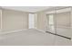 Neutral bedroom features tile floors and a large mirrored closet, maximizing space and light at 4512 24Th Ave S, Tampa, FL 33619