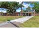 Charming single-story brick home with a spacious driveway and mature shade trees at 4512 24Th Ave S, Tampa, FL 33619