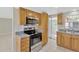 Well-lit kitchen featuring stainless steel appliances and wooden cabinetry at 4512 24Th Ave S, Tampa, FL 33619