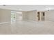 Spacious living room featuring tile flooring, neutral walls, and sliding glass doors leading to the outdoor space at 4512 24Th Ave S, Tampa, FL 33619