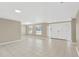 Bright living room with large windows, tile flooring, neutral paint, and a view of the front yard at 4512 24Th Ave S, Tampa, FL 33619