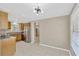 Spacious living area featuring tile flooring, modern light fixtures, and open access to the kitchen at 4512 24Th Ave S, Tampa, FL 33619