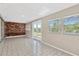 Bright sunroom boasts tile floors, brick accents, and a view of the private backyard through large windows at 4512 24Th Ave S, Tampa, FL 33619