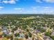 Community aerial view showcasing lush trees and neighborhood homes with clear blue skies at 4717 W Lawn Ave, Tampa, FL 33611
