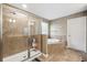Bathroom featuring large glass shower stall and large garden tub at 4717 W Lawn Ave, Tampa, FL 33611