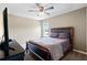 Comfortable bedroom with ceiling fan, bed, and television at 4717 W Lawn Ave, Tampa, FL 33611