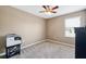 Neutral bedroom with ceiling fan, window, and carpeting at 4717 W Lawn Ave, Tampa, FL 33611