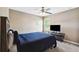 Cozy bedroom with blue comforter, ceiling fan, and window at 4717 W Lawn Ave, Tampa, FL 33611