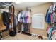 Walk-in closet featuring shelving, hanging racks, and window at 4717 W Lawn Ave, Tampa, FL 33611
