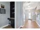 Hallway view featuring a decorative glass front door, a staircase, and a built-in desk with shelving at 4717 W Lawn Ave, Tampa, FL 33611