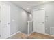 Hallway with carpet, multiple doors, and light gray walls at 4717 W Lawn Ave, Tampa, FL 33611