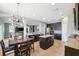 Open-concept kitchen features granite countertops, dark cabinetry, a center island, and seamless flow to the living area at 4717 W Lawn Ave, Tampa, FL 33611