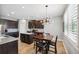 Spacious eat-in kitchen with stainless appliances, granite countertops, and center island at 4717 W Lawn Ave, Tampa, FL 33611