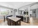 Open-concept kitchen features granite countertops, stainless steel appliances, and island at 4717 W Lawn Ave, Tampa, FL 33611