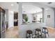 Elegant kitchen area featuring granite countertops, dark cabinetry, a center island, and stainless steel appliances at 4717 W Lawn Ave, Tampa, FL 33611
