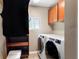 Laundry room with cabinetry, closet, modern washer and dryer at 4717 W Lawn Ave, Tampa, FL 33611