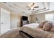 Comfortable bedroom featuring a ceiling fan, neutral color scheme, and large window at 4717 W Lawn Ave, Tampa, FL 33611