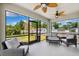 Cozy screened porch with comfortable seating and views of the lush backyard at 4717 W Lawn Ave, Tampa, FL 33611