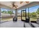 Relaxing screened porch featuring ceiling fans and expansive backyard views at 4717 W Lawn Ave, Tampa, FL 33611
