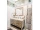 Elegant bathroom with double vanity, framed mirror, and decorative towel ladder at 5153 Miller Bayou Dr, Port Richey, FL 34668