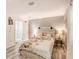 Bright bedroom featuring wood floors, accent lamps, and an accent wall at 5153 Miller Bayou Dr, Port Richey, FL 34668