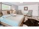 Bright bedroom featuring wood floors, and an accent wall at 5153 Miller Bayou Dr, Port Richey, FL 34668