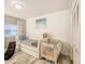 Bright bedroom with a trundle bed, crib, and wood laminate flooring at 5153 Miller Bayou Dr, Port Richey, FL 34668