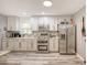 Well-lit kitchen features granite countertops, stainless steel appliances, and ample cabinet space at 5153 Miller Bayou Dr, Port Richey, FL 34668