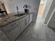 Bright kitchen with stainless steel faucet, granite countertops, and white cabinets at 5153 Miller Bayou Dr, Port Richey, FL 34668