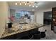Bright kitchen features an island with granite countertops, and stainless steel appliances at 5153 Miller Bayou Dr, Port Richey, FL 34668