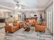Stylish living room featuring comfortable seating, and easy access to kitchen and billiards room at 5153 Miller Bayou Dr, Port Richey, FL 34668