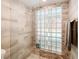 Modern shower featuring glass block window and neutral tile at 5153 Miller Bayou Dr, Port Richey, FL 34668