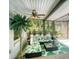 Relaxing sunroom featuring tropical style furniture and accents at 5153 Miller Bayou Dr, Port Richey, FL 34668
