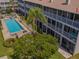 Aerial view of a condominium with a pool and lush landscaping at 521 Pinellas Bayway S # 301, St Petersburg, FL 33715
