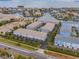 Aerial view of waterfront condo community featuring manicured landscaping, community pool, and boat access to the bay at 521 Pinellas Bayway S # 301, St Petersburg, FL 33715