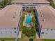 Aerial view showcases the community pool nestled between well-maintained condo buildings, offering a private retreat at 521 Pinellas Bayway S # 301, St Petersburg, FL 33715