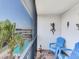 Outdoor balcony with comfortable seating and views of the pool area at 521 Pinellas Bayway S # 301, St Petersburg, FL 33715