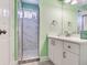 Updated bathroom with white vanity, glass shower, and contemporary fixtures at 521 Pinellas Bayway S # 301, St Petersburg, FL 33715